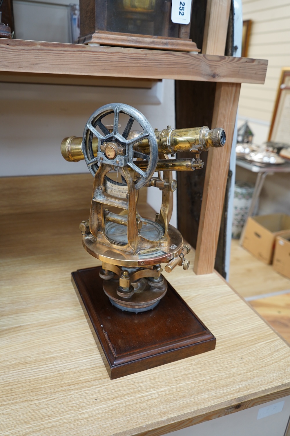 An early 20th century American brass theodolite by Keuffel and Esser Co. mounted on a mahogany base, 39.5cm high. Condition - fair to good.